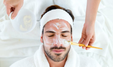 Man with clay facial mask in beauty spa. Portrait of man with clay facial mask in beauty spa.